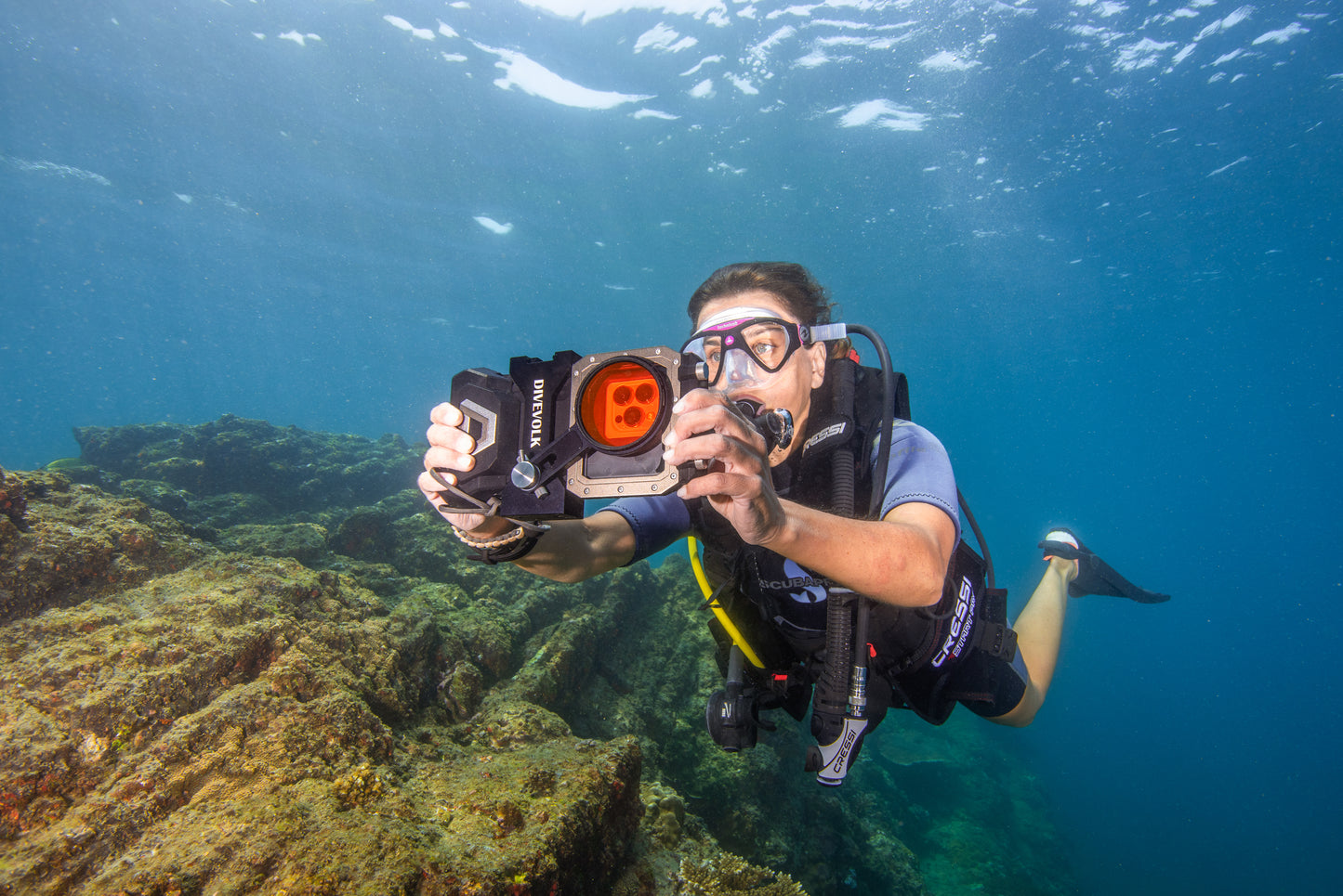 A SCUBA Diver takes a shot underwater with the Divevolk Seatouch 4 Max Filters Kit with Red Colour correcting filter