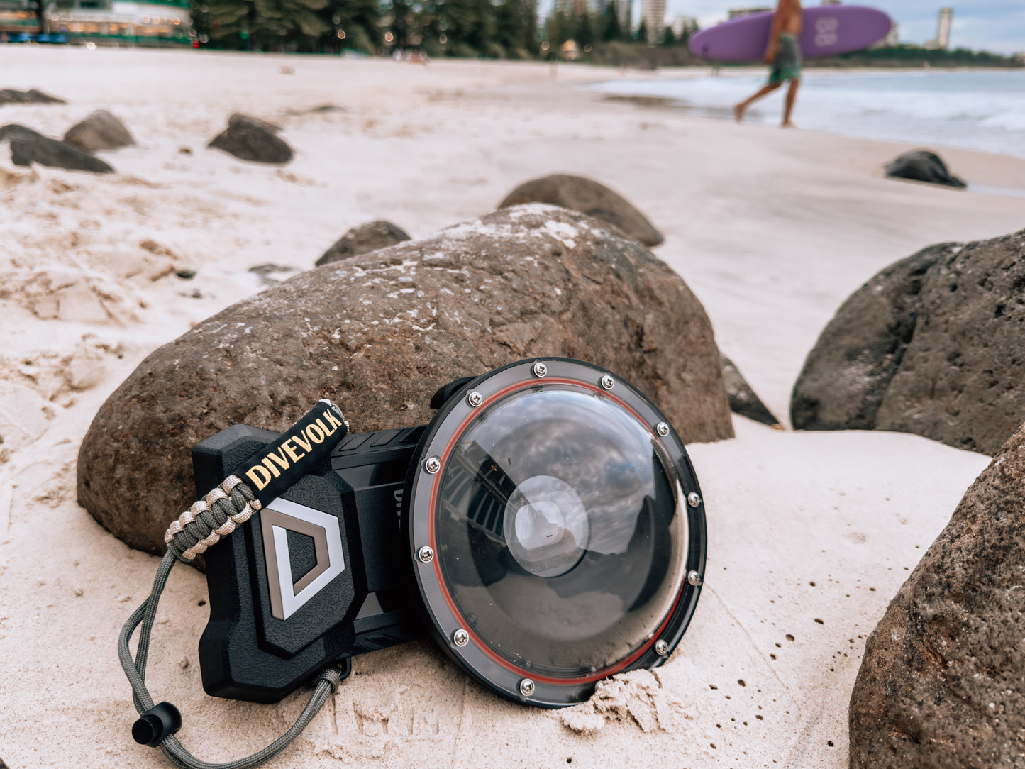 The Divevolk Seatouch 4 Max Smartphone Housing situated on the beach with the Dome lens installed