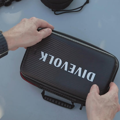 Person holding a black case with 'Divevolk' branding on a light blue surface