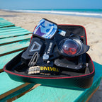 Divevolk diving equipment set on a teal table with a beach background