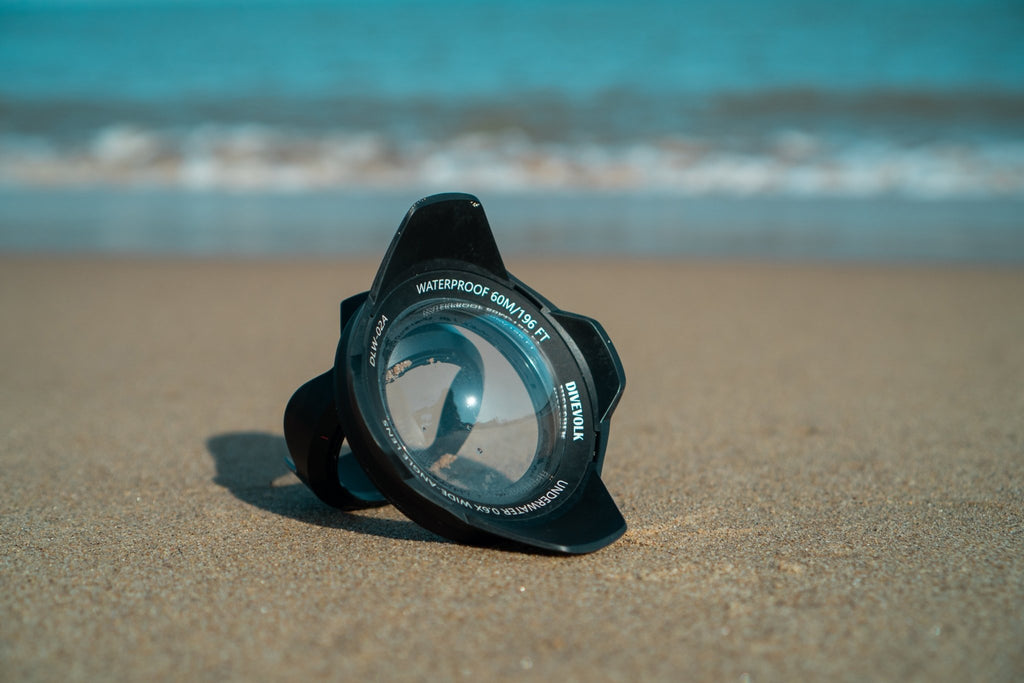 The Divevolk DLW - 02A Wide - Angle Conversion Lens on a beach in the sand