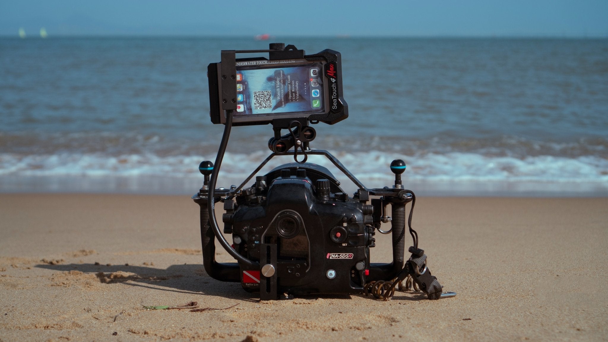 SeaLink Underwater Wi - Fi Signal Transmitter mounted on a Nauticam Waterproof Camera Housing on a Beach