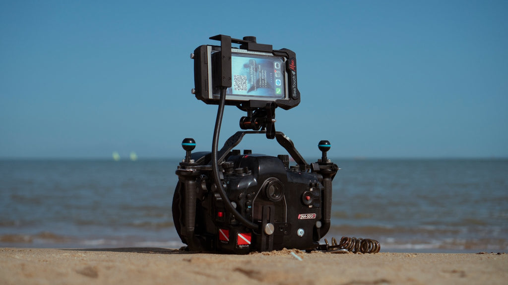 SeaLink Underwater Wi - Fi Signal Transmitter mounted on a Nauticam Waterproof Camera Housing on a Beach