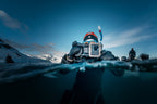 A free diver in the Arctic uses the Divevolk Seatouch Surface Dome to take a split - shot photo of their buddy who is also using a Divevolk Seatouch 4 Max Waterproof phone housing