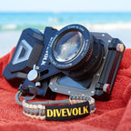 Divevolk SeaTouch 4 Max PLUS Housing and Macro Kit with 'Divevolk' branding on a red towel by the ocean