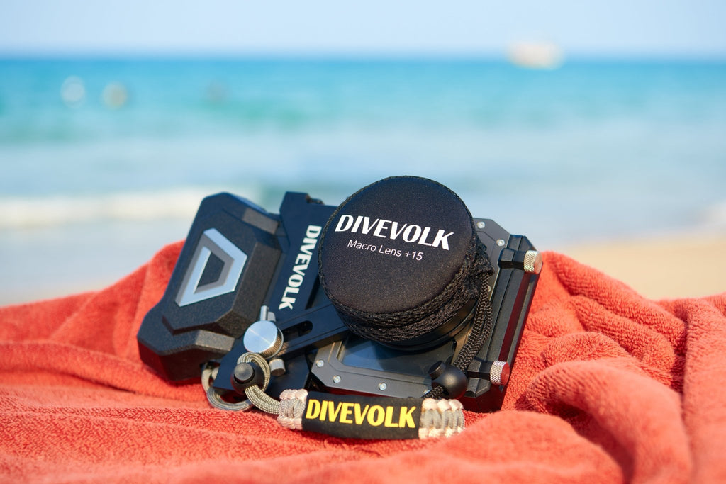 Divevolk SeaTouch 4 Max Plus Macro Kit placed on a red towel with a beach and ocean background.